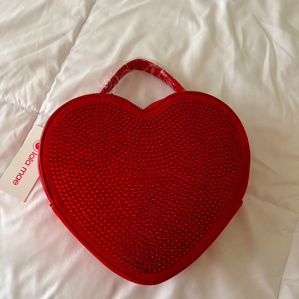 Red heart purse measuring 8 1/2”X 7 1/2”. Brand new never used